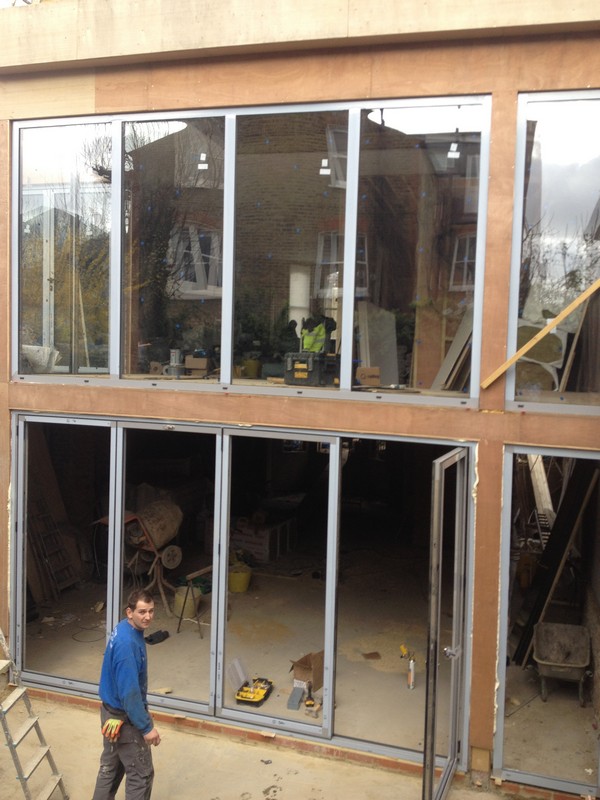 Aluminium bi-fold doors with two-storey glazing in Twickenham