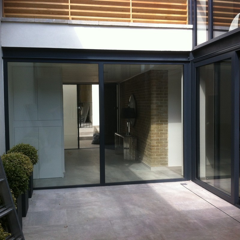 Floor-to-ceiling sliding doors opening to courtyard in Twickenham