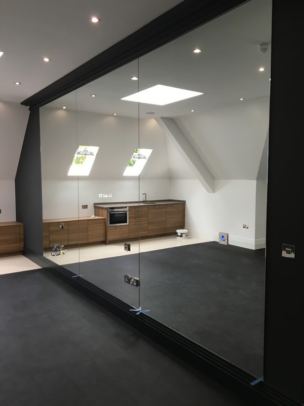Frameless glass partition in loft conversion by Twickenham glaziers