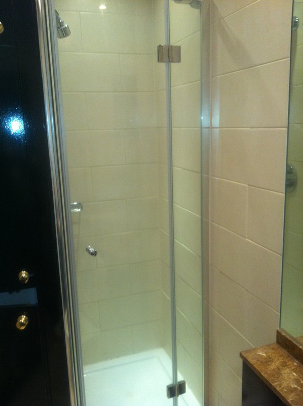 Frameless glass shower enclosure with chrome fittings in Twickenham