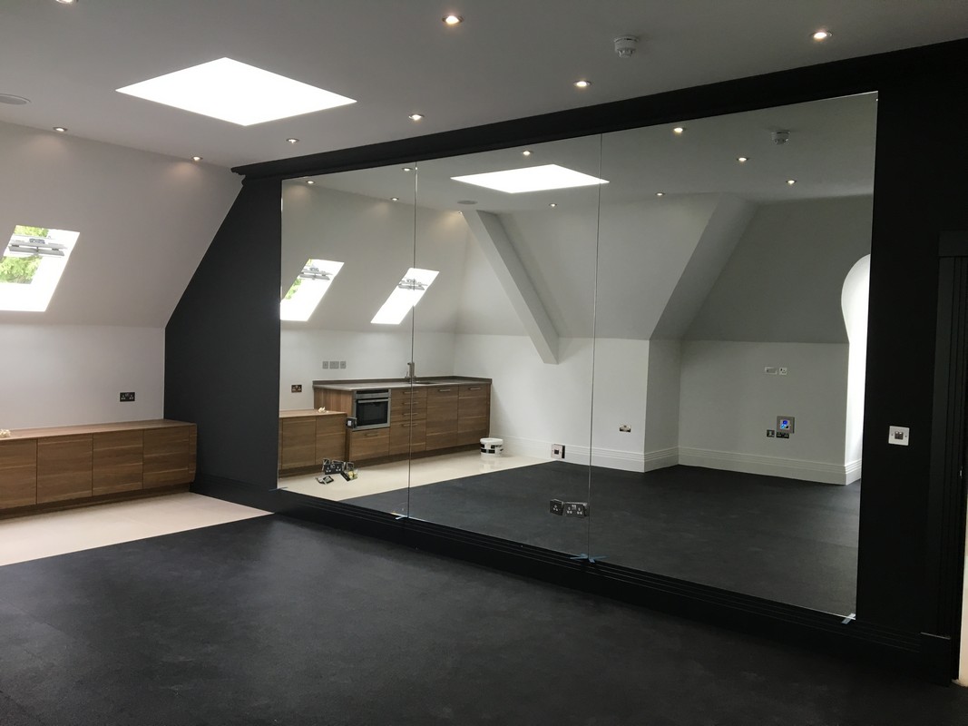 Frameless glass wall dividing loft conversion in Twickenham