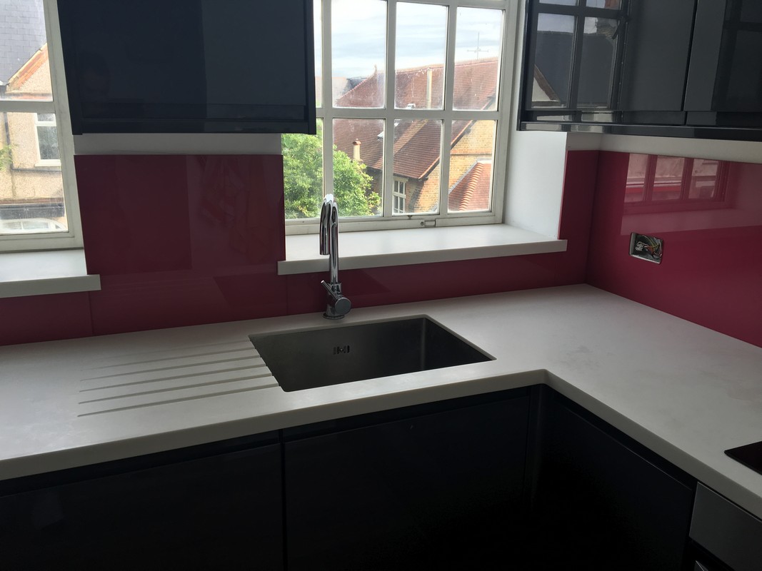 Deep plum coloured glass splashback in modern Twickenham kitchen